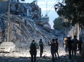 Journalists inspect the damage to Gaza City following bombing by the Israeli army.